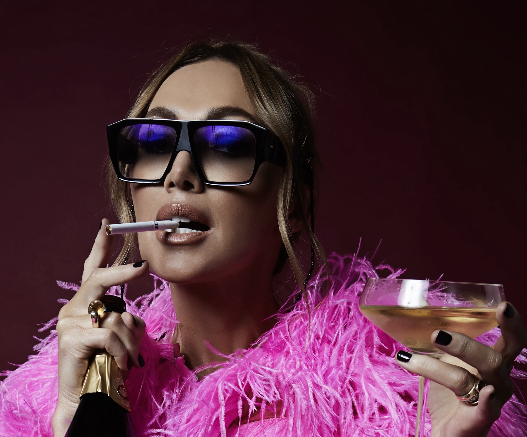 Campaign mood shot — Midlife Crisis 2 with pink feathers, cigarette and martini glass